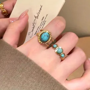 Detailed macro view of vintage gold rings with turquoise-colored stones