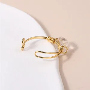 Macro detail of a handmade wire-wrapped ring with a clear crystal stone accent.