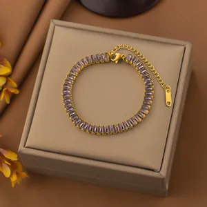 Close-up of gold-plated stainless steel bracelet featuring purple baguette zircons.