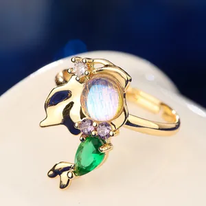 Macro view of iridescent moonstone ring with mermaid tail colorful gemstone design