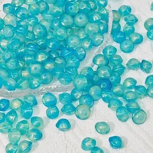 Macro shot of 8x10mm blue UFO glass beads with marbled golden shimmer for DIY jewelry.