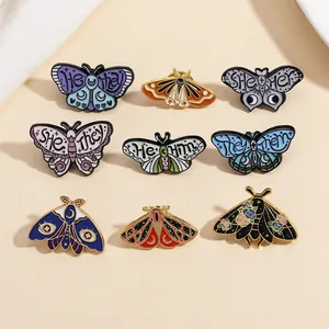 Butterfly moth enamel pins with pronouns for inclusive and unique fashion styles.