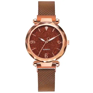Close-up of women's starry sky dial watch with rose gold magnetic Milanese band