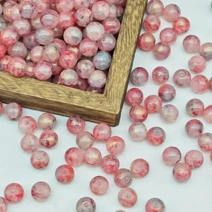 Close-up of pink water-dyed glaze beads with gold flecks for DIY handmade jewelry