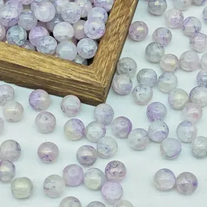 Close-up detail of purple water-dyed beads with elegant gold foil marbling texture