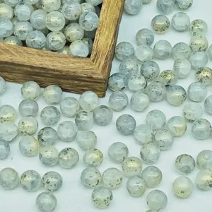 Detail view of 8-10mm gold-sprinkled opal glass beads with unique mottled texture.