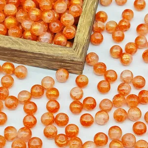 Macro detail of orange gold-sprinkled glass beads with straight holes for DIY jewelry