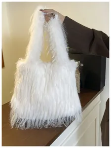 Large white faux fur tote bag being held, showing its fluffy texture and casual style.