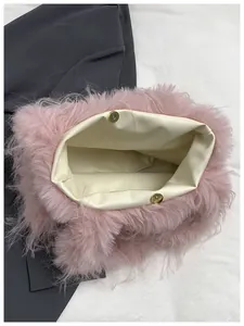 Detail view showing internal cream lining and magnetic closure of pink faux fur tote bag