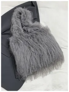 Close-up detail of a grey faux fur tote bag showing its long fluffy texture and soft feel
