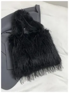 Close-up of black fluffy faux fur shoulder bag with long hair texture and soft feel