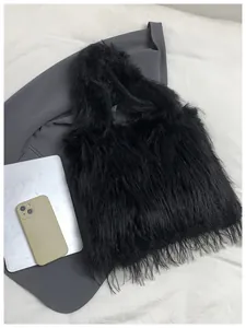 Detailed macro view of the fluffy black faux fur texture on this trendy shoulder bag