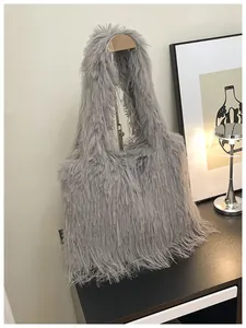 Detailed view of a grey fluffy feathered shoulder bag on a minimalist display stand