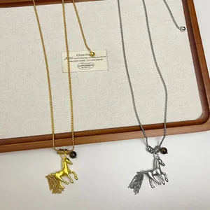 Elegant gold and silver metal horse pendant necklaces on a long chain for women.