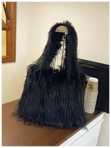 Close-up of the large black shaggy faux fur shoulder bag with soft plush texture