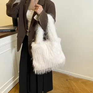 Large capacity white faux fur shoulder bag worn by model in a chic indoor setting