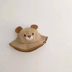 Close-up of a cute khaki baby bucket hat with 3D bear ears and embroidered face design