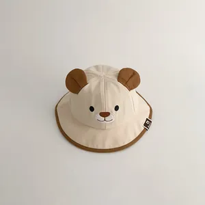 Detailed close-up view of a cream baby bucket hat featuring cute bear ears and embroidery
