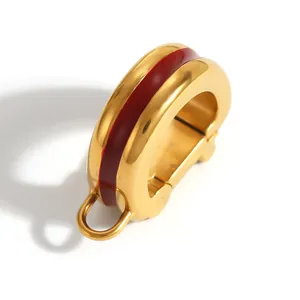 Detail view of gold-plated stainless steel fish mouth clasp with red stripe inlay.