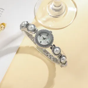 Close-up detail of the elegant pearl bracelet strap on this silver-tone ladies watch