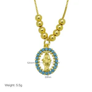 Macro detail of Virgin Mary pendant necklace with blue beads and 18K gold plating