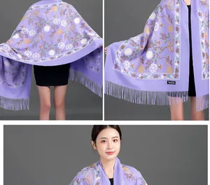 Close-up of purple embroidered floral scarf with elegant fringe detail.
