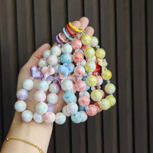 Close-up of colorful beaded bow keychains in candy colors with pearlescent finish