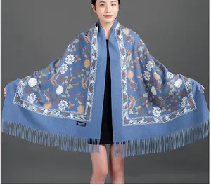 Detailed view of elegant blue floral embroidery shawl with soft tassels for women
