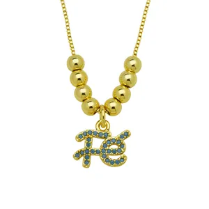 Close-up of 18K gold plated necklace with blue zircon "Fe" pendant on white background