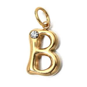 Close-up of gold stainless steel letter B charm with a clear sparkling birthstone