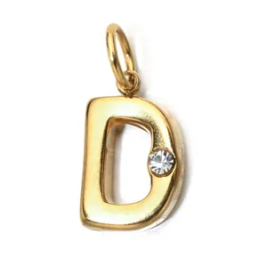 Detailed macro view of a gold-plated letter D pendant with a clear birthstone.