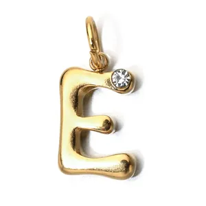 Detailed view of a gold-colored bubble letter E pendant featuring a small clear stone