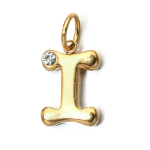 Close-up of a gold-plated stainless steel letter I pendant with a clear birthstone