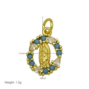 Detail view of an 18K gold-plated Virgin Mary pendant with blue and clear stones.