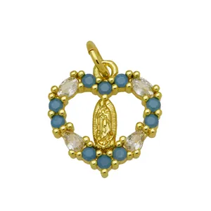 Macro view of gold plated heart pendant featuring Virgin Mary and blue zircons.