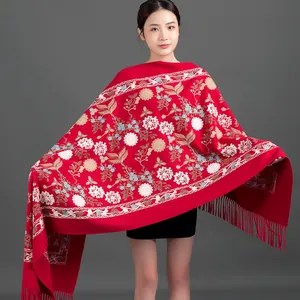 Elegant red winter shawl featuring detailed hand-embroidered floral patterns and fringe