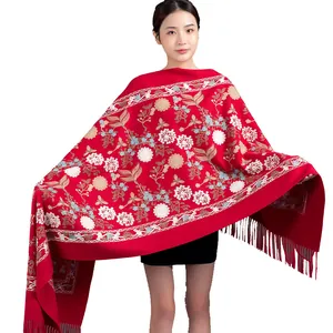 Elegant red winter scarf for women featuring intricate floral embroidery and tassels.