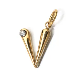 Macro view of a gold-plated stainless steel letter V pendant with a clear birthstone