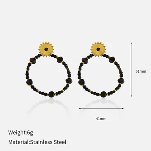 Detail of gold plated stainless steel earrings with black beads, dimensions 61mm x 41mm