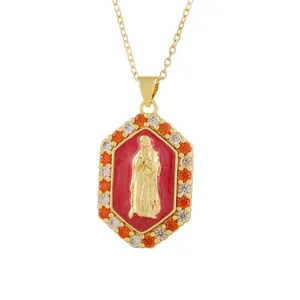 Macro detail of a vintage gold octagonal pendant with red enamel and religious relief