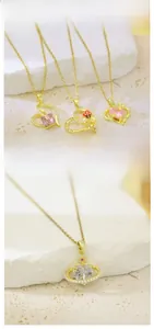 Detailed close-up view of gold heart pendant necklace with pearl border and white crystal