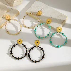 Detailed view of 18K gold plated beaded hoop earrings in black, turquoise, and white.