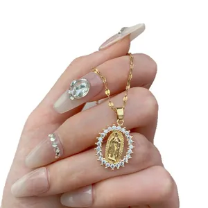 Detailed macro view of a gold Virgin Mary pendant necklace featuring a cubic zirconia halo