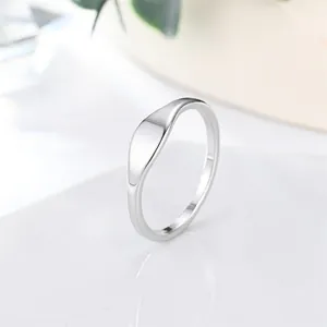 Detailed macro view of a polished minimalist stainless steel signet ring for women