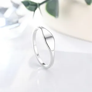 Macro view of a minimalist polished silver stainless steel signet ring for women