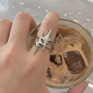 Close-up detail of a silver irregular star-shaped adjustable open ring for women.