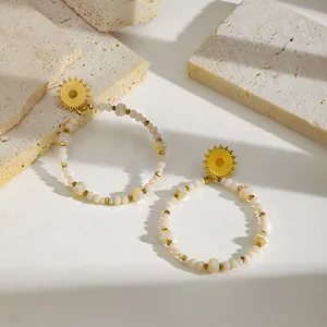 Detailed shot of 18K gold plated hoop earrings with natural stone beads