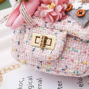 Close-up of cute pink kids tweed bag with flower and ribbon decorations