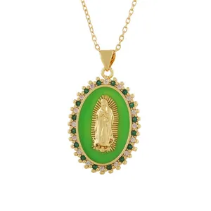 Close-up of vintage gold portrait relief pendant with green enamel and crystals