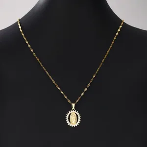 Close-up of elegant gold Virgin Mary pendant necklace with a sparkling zircon crystal halo